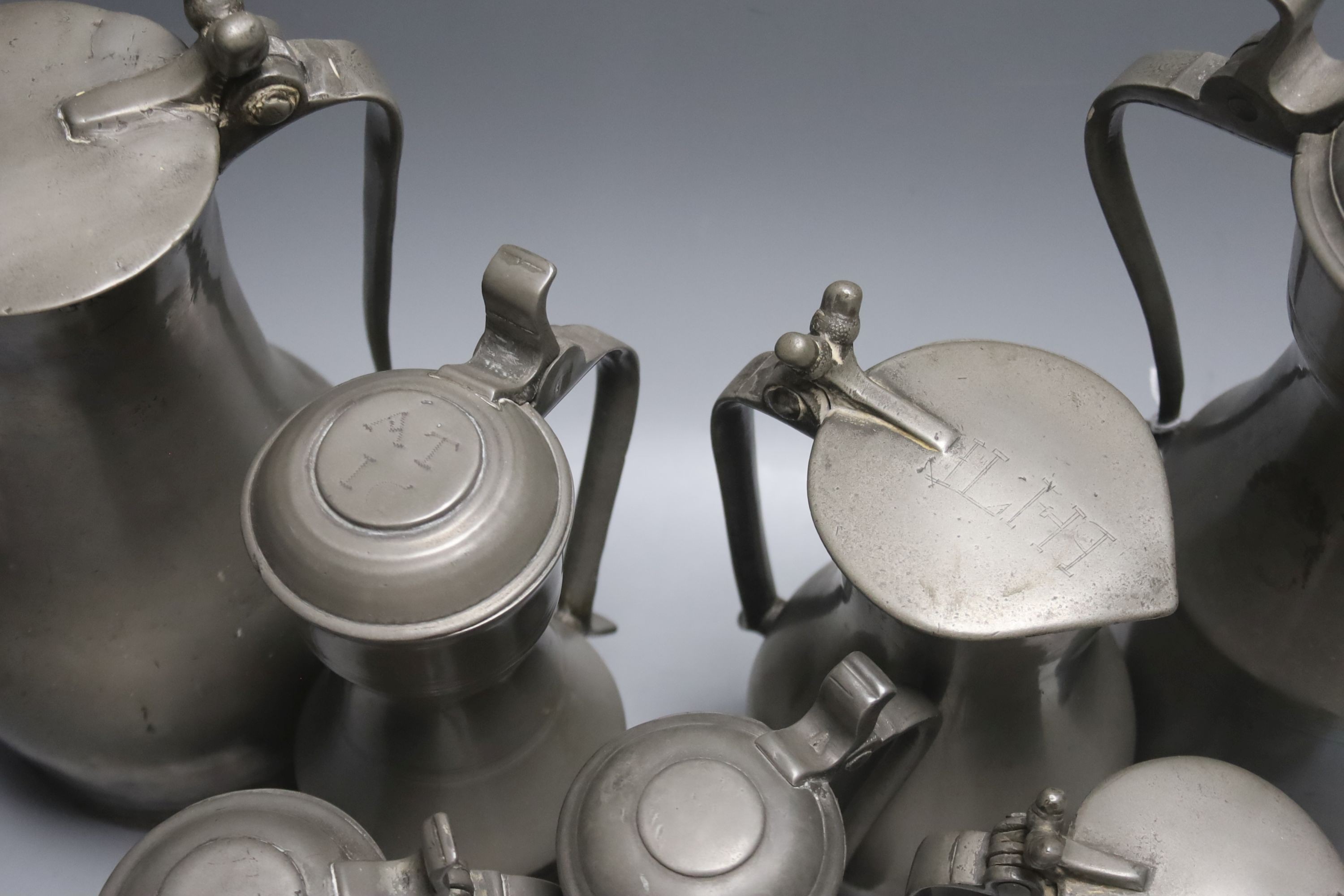 A graduated set of three Jersey pewter flagon measures, by John de St Croix, c.1730, tallest 27cm, and four pewter measures, c.1780, tallest 28cm (7)